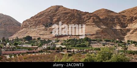 the mount of the temptation of jesus in jericho Palestine showing the monastery and the cable car dock on the side of the limestone cliffs Stock Photo