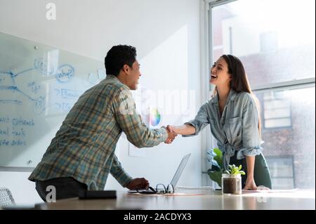 Business people shaking hands in office Stock Photo