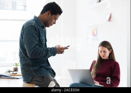 Colleagues working together in office Stock Photo