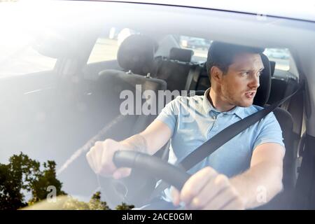 displeased young man or driver driving car Stock Photo