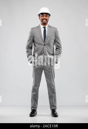 indian male architect in helmet over grey Stock Photo