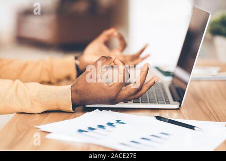 Closeup of african american businessman meditating in office Stock Photo