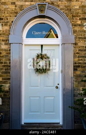 A decorative winter Wreath hanging on a front door in the Suffolk Town of Clare, England, UK Stock Photo
