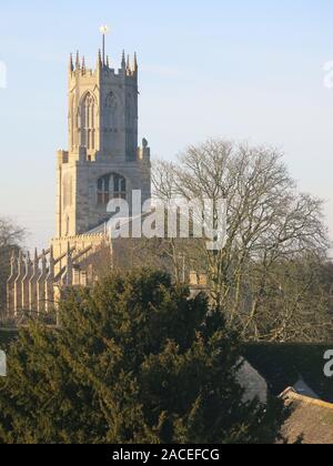 View in the winter sunshine of the 15th century church of St Mary & All Saints in the Northamptonshire village of Fotheringhay; December 2019. Stock Photo