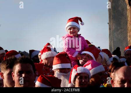 Around 500 people took part in the Monmouth Santa Fun Run, starting and finishing at the landmark, historic Monnow Bridge on Sunday 1st December. The Stock Photo