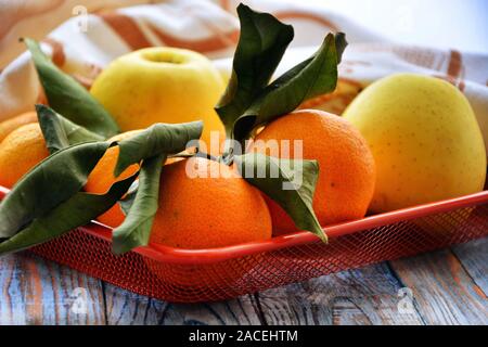 Fresh apples and mandarins. Healty fruit tangerines on wooden table. Stock Photo