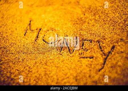 Black text Money on shiny golden background. Stock Photo