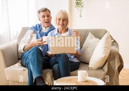 Senior couple using laptop, watching video or shopping online Stock Photo