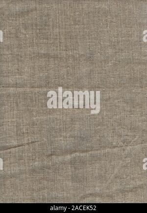Linen cloth with rough weaving. Vertical format. Country background. Close up natural linen texture as background. Burlap Fabric Patch Piece. Rustic Stock Photo