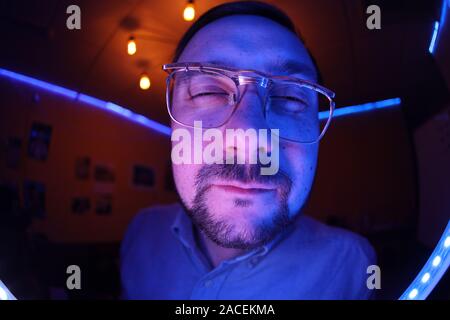 Mans face wide reaching to the camera, wide angle Stock Photo