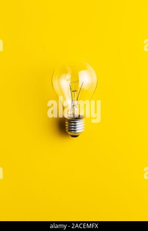 Classic light bulb on yellow background. Stock Photo