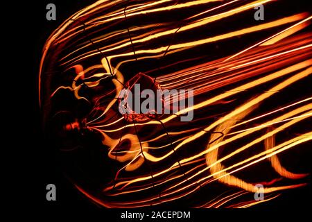 Close up of a vintage electric light bulb dimmed to show its colourful filiment Stock Photo