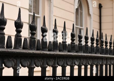black painted old fence with spiked ornament at victorian building in the city of London, England Stock Photo