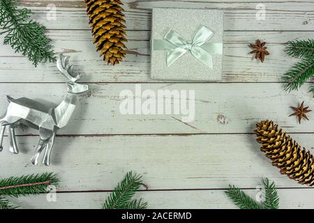 Christmas frame background flat lay on white wood with gift box and other natural decoration . Stock Photo