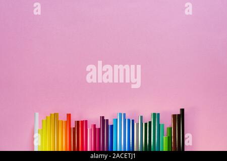 spectral sequence of color pencils on pink background. Close up, lay flat Stock Photo