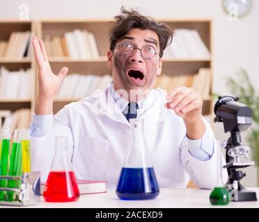 The mad crazy scientist doctor doing experiments in a laboratory Stock Photo