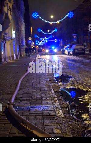 RIGA, LATVIA. 1st December 2019. Firse hose on the ground. Emergency rescue services; firefighters and police near building, where member's of  Latvian Parliament Artuss Kaimins appartment was in fire. Stock Photo