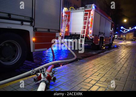 RIGA, LATVIA. 1st December 2019. Firse hose on the ground. Emergency rescue services; firefighters and police near building, where member's of  Latvian Parliament Artuss Kaimins appartment was in fire. Stock Photo