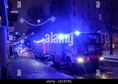 RIGA, LATVIA. 1st December 2019. Emergency rescue services; firefighters and police near building, where member's of  Latvian Parliament Artuss Kaimins appartment was in fire. Stock Photo