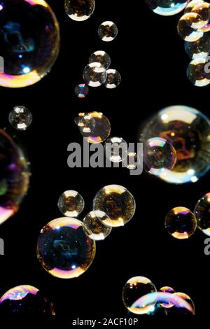 Bubbles. Different size bubbles, showing colourful patterns in their surface film. Stock Photo