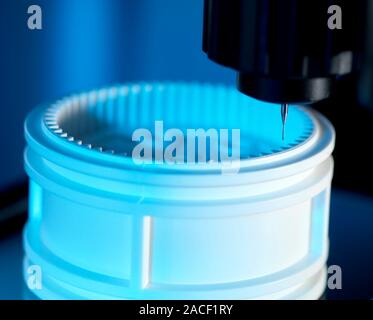 3D measurement of an object. Close-up of a coordinate measurement machine (black) measuring the internal proportions of a cylinder cog (white). Machin Stock Photo