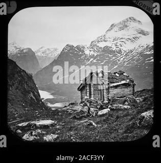 photograph of a c 1888 black & white Magic Lantern glass slide on a light box of a wooden hut above Nordfjord Oldendal Brynestad Saeter Norway.  Original photographers copyright expired. Digital photograph copyright Doug Blane. Digital restoration & editing copyright Doug Blane. Stock Photo