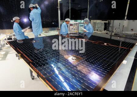 Satellite solar panels construction. Engineers working on the construction of solar panels used for satellites. The solar panels convert the energy of Stock Photo