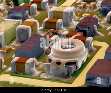 Surface-mount device (SMD), coloured scanning electron micrograph (SEM). An SMD is a type of circuit board where the components are directly mounted o Stock Photo
