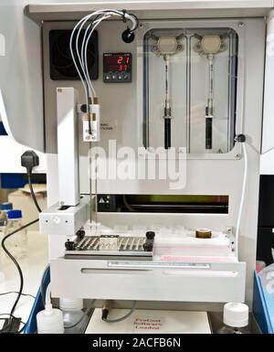 Protein analysis. Samples inside a protein digester robot. This machine chemically breaks down the samples' proteins into their constituent parts for Stock Photo