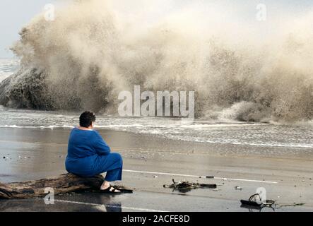 Storm waves. Woman watching large waves caused by the storm surge of approaching Hurricane Ike. Ike struck the southeast Texas coast on 13th September Stock Photo