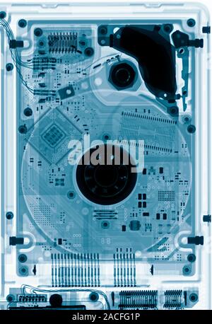 Laptop hard drive. Coloured X-ray of a laptop's hard drive, showing its internal structure. Stock Photo