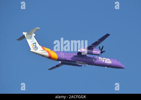 Flybe plane taking off from London City airport against a clear blue sky Stock Photo