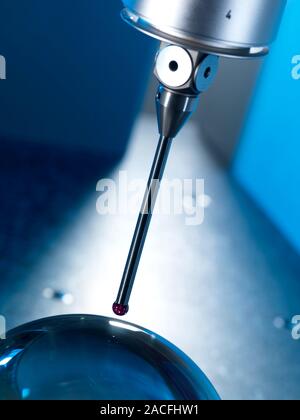 3D measurement machine probe. Close-up of the probe head of a coordinate measurement machine measuring the dimensions of a sphere (bottom). Machines l Stock Photo