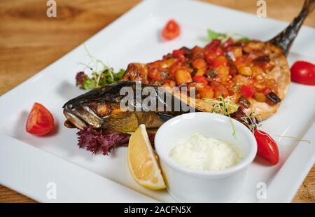 Grilled fish stuffed with different vegetables Stock Photo