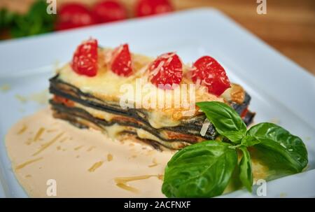 Black plate with delicious lasagna on white background Stock Photo - Alamy