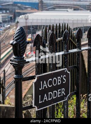 Jacob's Ladder steps sign on railings with Waverley railway station tracks, Edinburgh, Scotland, UK Stock Photo