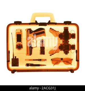 Spy's case. Coloured X-ray of a case containing various items used by a spy. Stock Photo