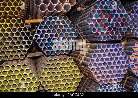 stockpiled industrial pipes , metallic background Stock Photo