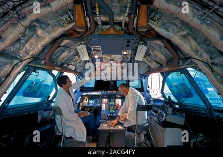 Passenger aircraft construction. System technicians installing and checking the avionics system, the cockpit's electrical equipment, of an Airbus pass Stock Photo