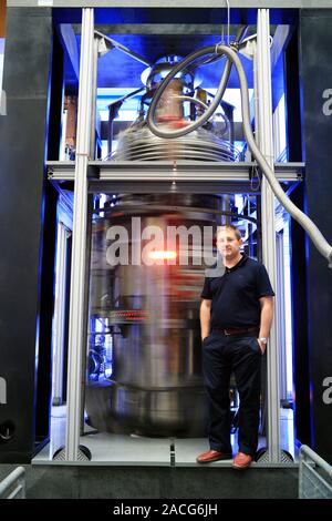 Dark matter detector. Research scientist standing in front of the cryostat of the PVLAS (Polarizzazione del Vuoto con Laser) optical apparatus. The cr Stock Photo
