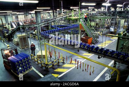 Factory production line. Factory workers on the production line of a lubricants factory. Stock Photo