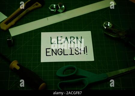 Handwriting text Learn English. Conceptual photo gain acquire knowledge in new language by study Carpentry equipments and plain paper scattered everyw Stock Photo