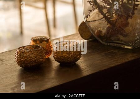 Three golden glass ornamental candle holders with cblurry background Stock Photo