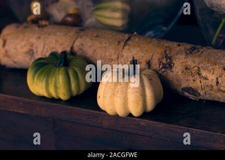 Mini pumpkins with a birch stem and christmas decorations in the background. Selective focus Stock Photo