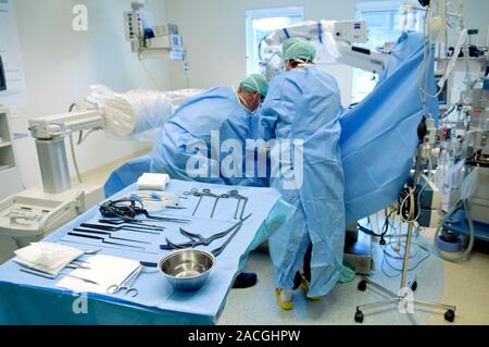 Slipped disc microendoscopy surgery. Surgeons performing an operation on a herniated (slipped) intervertebral disc using microendoscopic discectomy (M Stock Photo