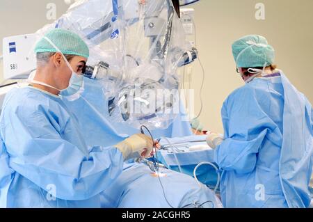 Slipped disc microendoscopy surgery. Surgeons performing an operation on a herniated (slipped) intervertebral disc using microendoscopic discectomy (M Stock Photo