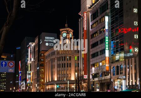 Night view of Ginza fashion and boutique district in the very center of Tokyo, with the famous art deco Wako Building with its iconic Clocktower Stock Photo