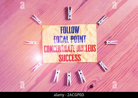 Writing note showing Follow Focal Point Concentrate Nucleus Success. Business concept for Concentration look for target Colored clothespin papers empt Stock Photo