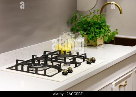 Modern kitchen counter with built-in 4 burner gas hob. Selective focus. Stock Photo
