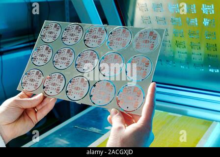 LED street lighting. Technician holding a printed circuit board (PCB) for an LED street lighting system to be used in Torraca, Italy. Torraca is the f Stock Photo